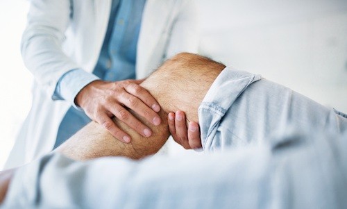 board certified vein doctor checks leg tenderness swelling heaviness pain